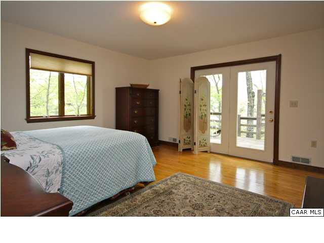 57 Laguna Road Palmyra, VA 22963 - Photo 20 of 32 a living room with a bed furniture and a large window