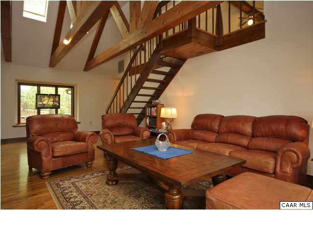 57 Laguna Road Palmyra, VA 22963 - Photo 6 of 32 a living room with furniture a ceiling fan and a rug