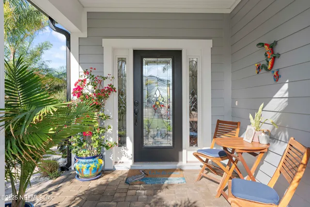 a view of a dining room with furniture a chandelier and wooden floor