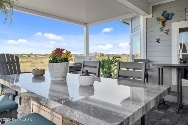 a living room with furniture a rug and kitchen view
