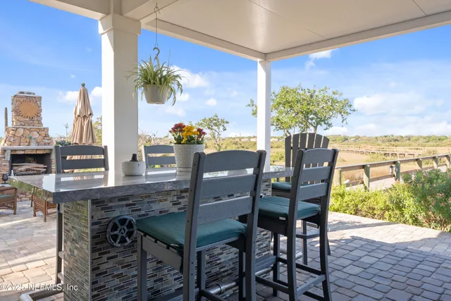 a living room with furniture a fireplace and a chandelier