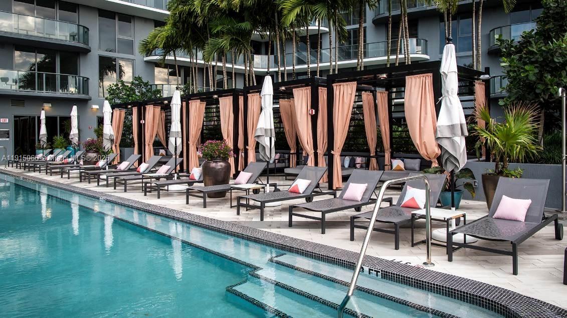121 Northeast 34th Street, Unit 2811 Miami, FL 33137 - Photo 16 of 35 a view of swimming pool with chairs and bench in patio