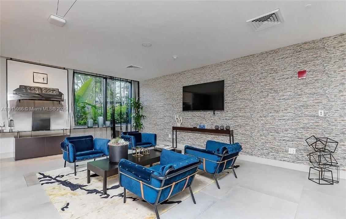 121 Northeast 34th Street, Unit 2811 Miami, FL 33137 - Photo 27 of 35 a living room with furniture and a flat screen tv