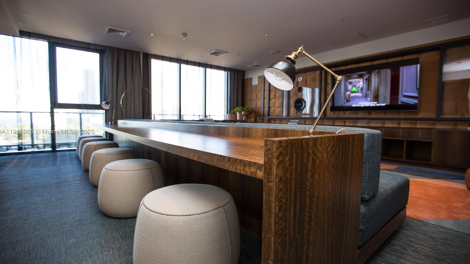 121 Northeast 34th Street, Unit 2811 Miami, FL 33137 - Photo 33 of 35 a living room with furniture a large window and a flat screen tv