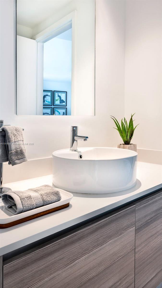 121 Northeast 34th Street, Unit 2811 Miami, FL 33137 - Photo 7 of 35 a bathroom with a potted plant on the counter and a window