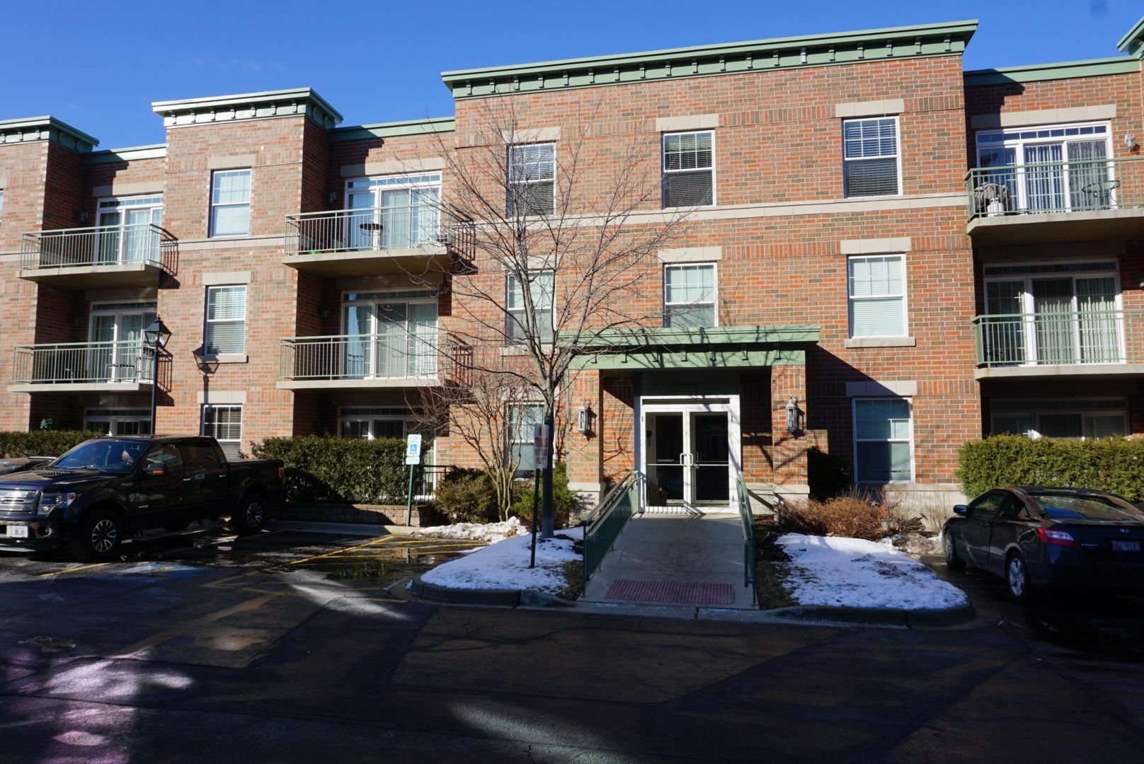 133 West Palatine Road, Unit 103A Palatine, IL 60067 - Photo 2 of 16 a view of a building with a yard