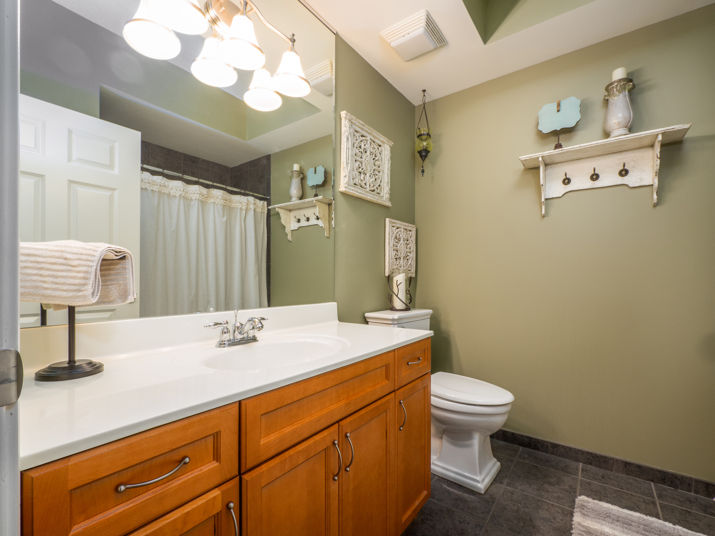 133 West Palatine Road, Unit 103A Palatine, IL 60067 - Photo 11 of 16 a bathroom with a sink a toilet and mirror