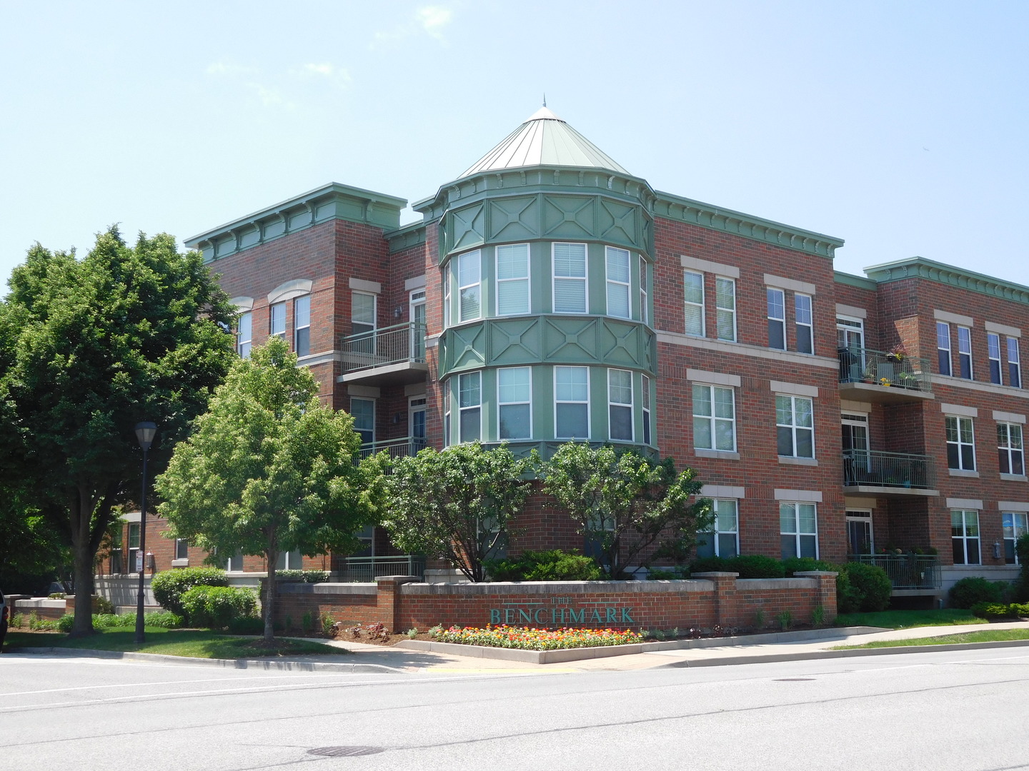 133 West Palatine Road, Unit 103A Palatine, IL 60067 - Photo 16 of 16 a front view of a residential apartment building with a yard