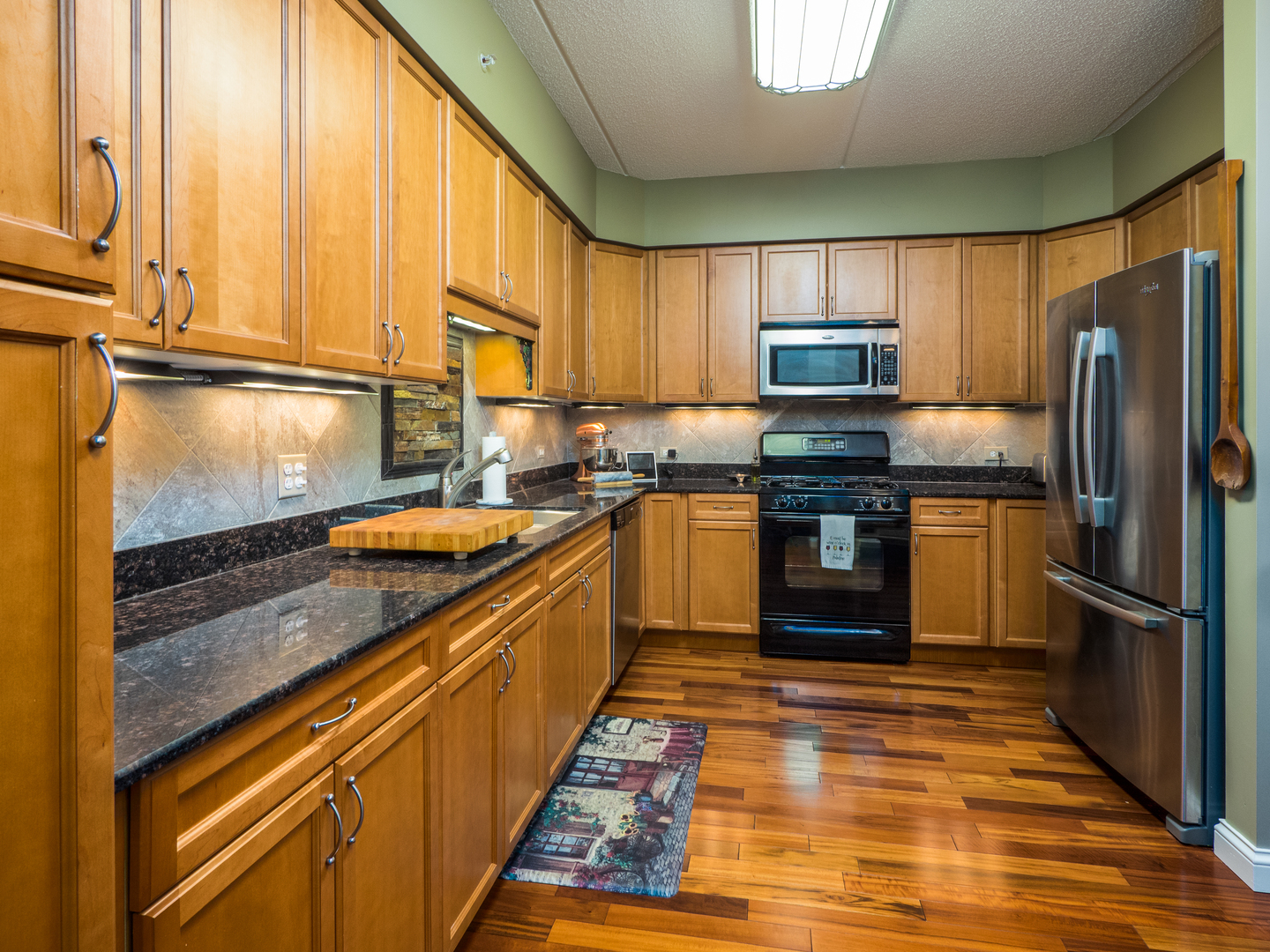 133 West Palatine Road, Unit 103A Palatine, IL 60067 - Photo 3 of 16 a kitchen with stainless steel appliances granite countertop a refrigerator a stove and a sink
