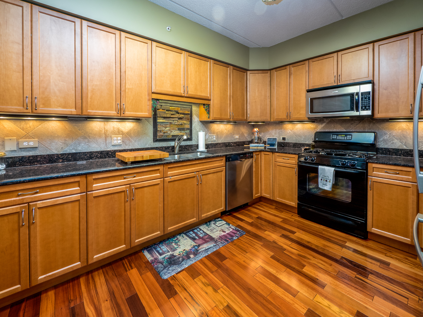 133 West Palatine Road, Unit 103A Palatine, IL 60067 - Photo 4 of 16 a kitchen with stainless steel appliances granite countertop a stove sink and cabinets
