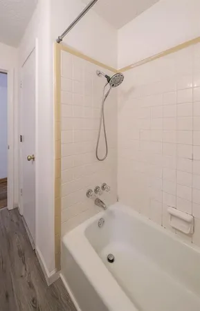 a bathroom with a tub and a shower
