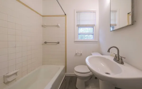 a bathroom with a sink toilet and shower