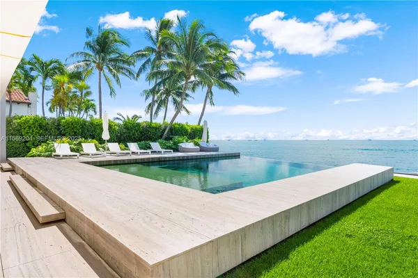 a view of a house with a backyard porch and sitting area