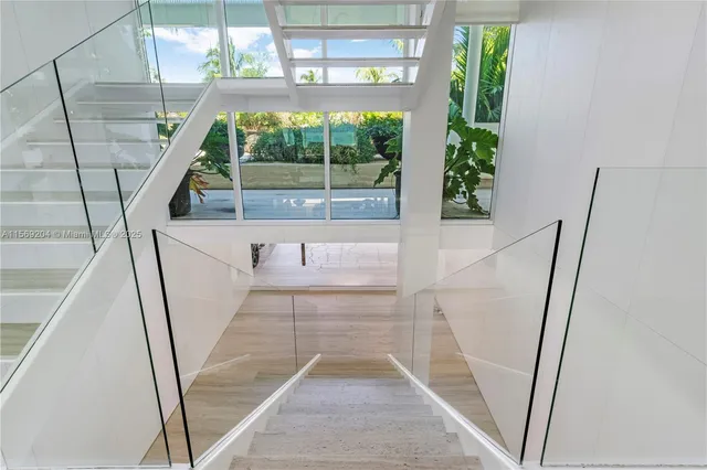 a white bath tub sitting in a bathroom next to a window