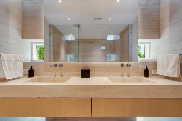 a view of a lake with a floor to ceiling window and palm tree