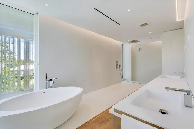 a view of a lake with a floor to ceiling window and palm tree