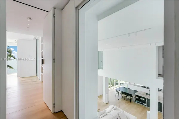 a living room with furniture flat screen tv and a large window