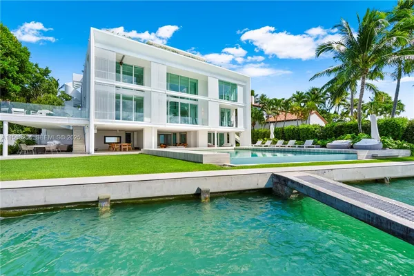 a view of a house with swimming pool and sitting area