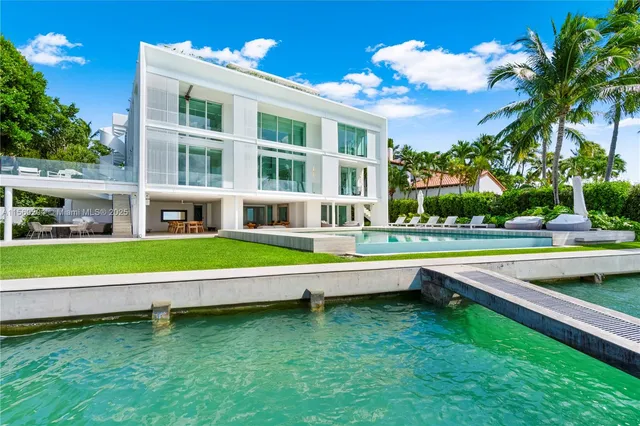 a living room with furniture flat screen tv and a large window