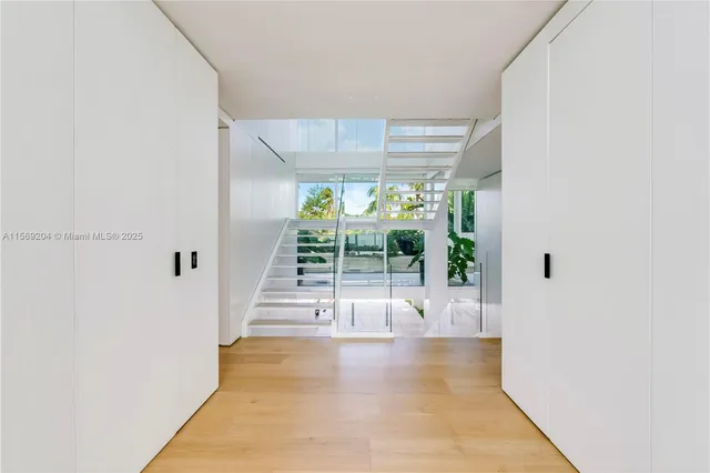 a living room with furniture and a large window with balcony view