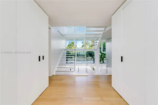a living room with furniture and a large window with balcony view