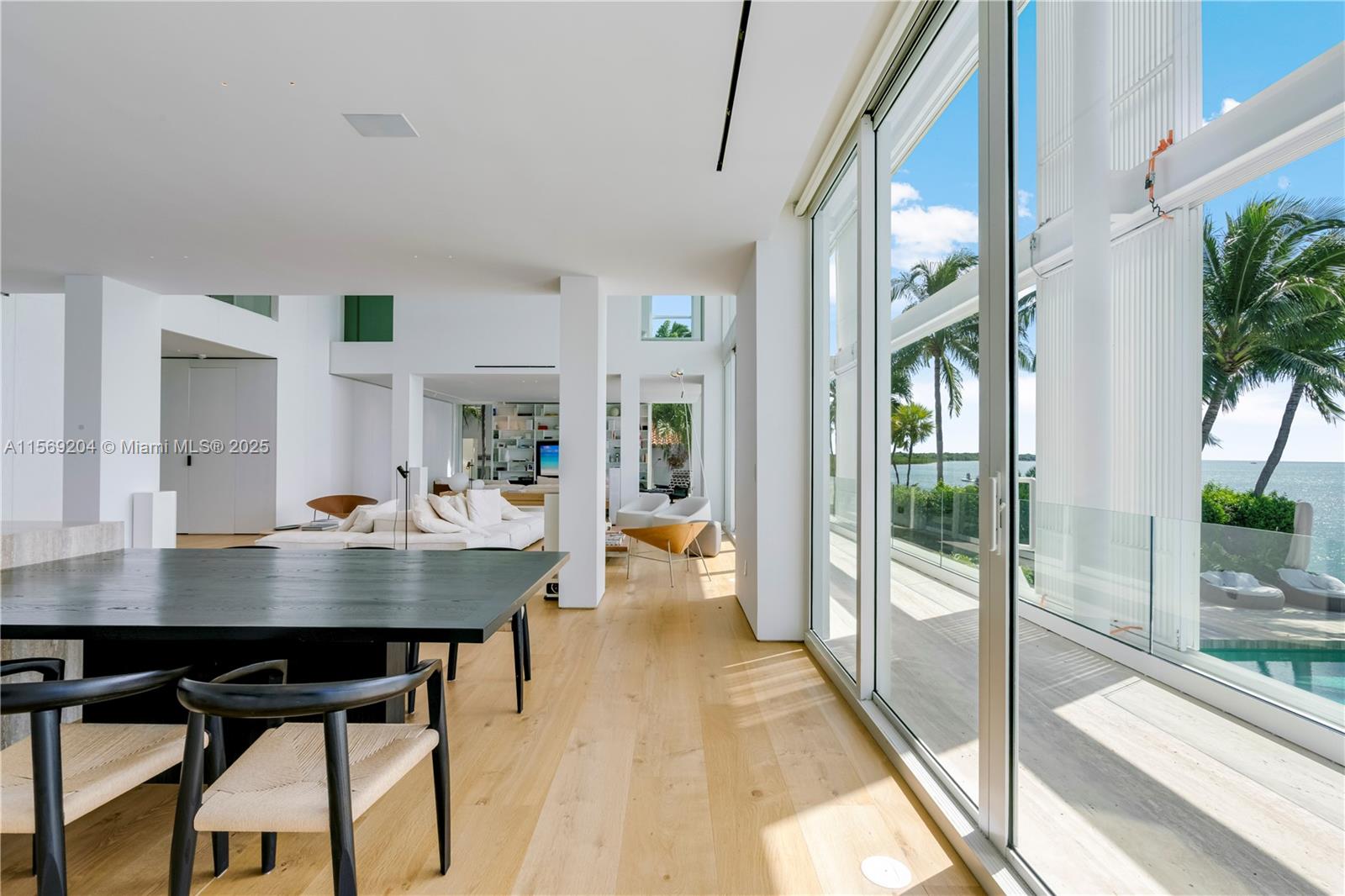 440 South Mashta Drive Key Biscayne, FL 33149 - Photo 88 of 100 a view of a dining room with furniture and a floor to ceiling window