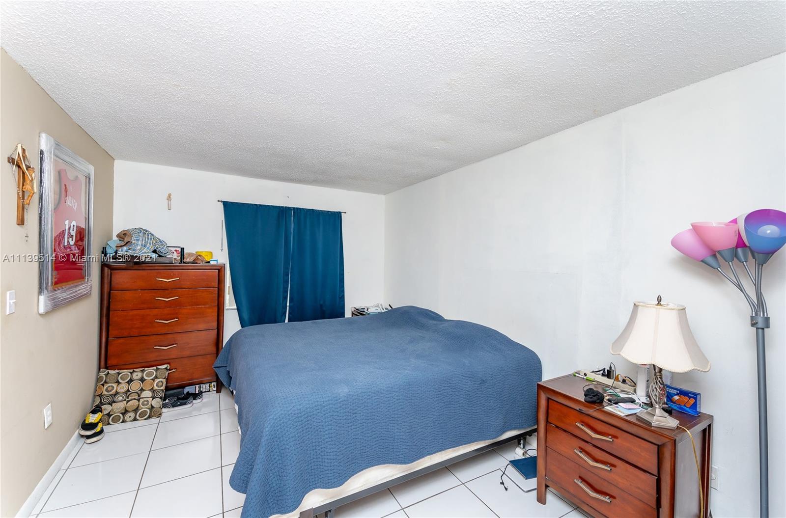 15280 Southwest 80th Street, Unit 11 Miami, FL 33193 - Photo 11 of 13 a bedroom with a bed and wooden floor