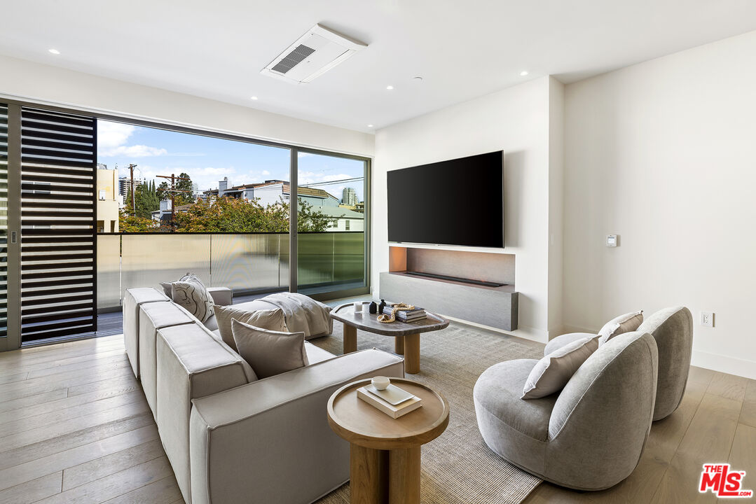 1644 Malcolm Avenue, Unit 420 Los Angeles, CA 90024 - Photo 15 of 64 a living room with furniture and a flat screen tv