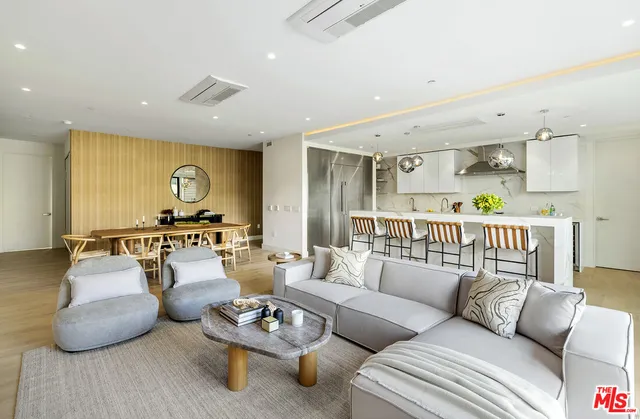 a kitchen with stainless steel appliances a stove a sink cabinets and a window