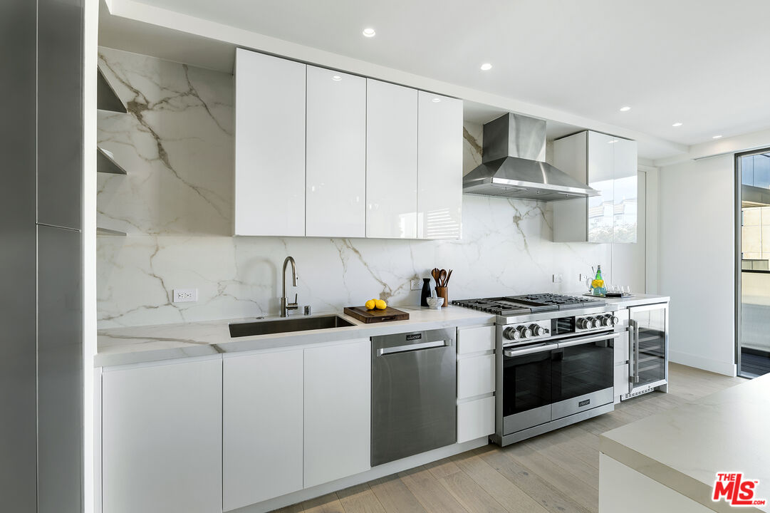 1644 Malcolm Avenue, Unit 420 Los Angeles, CA 90024 - Photo 22 of 64 a kitchen with stainless steel appliances granite countertop a sink and a stove