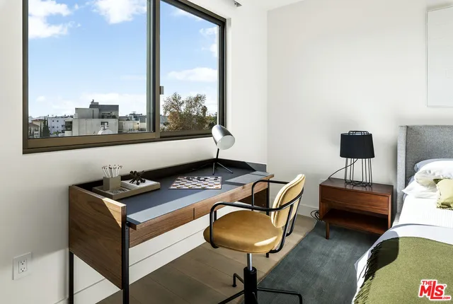 a bed room with a bed and a mirror