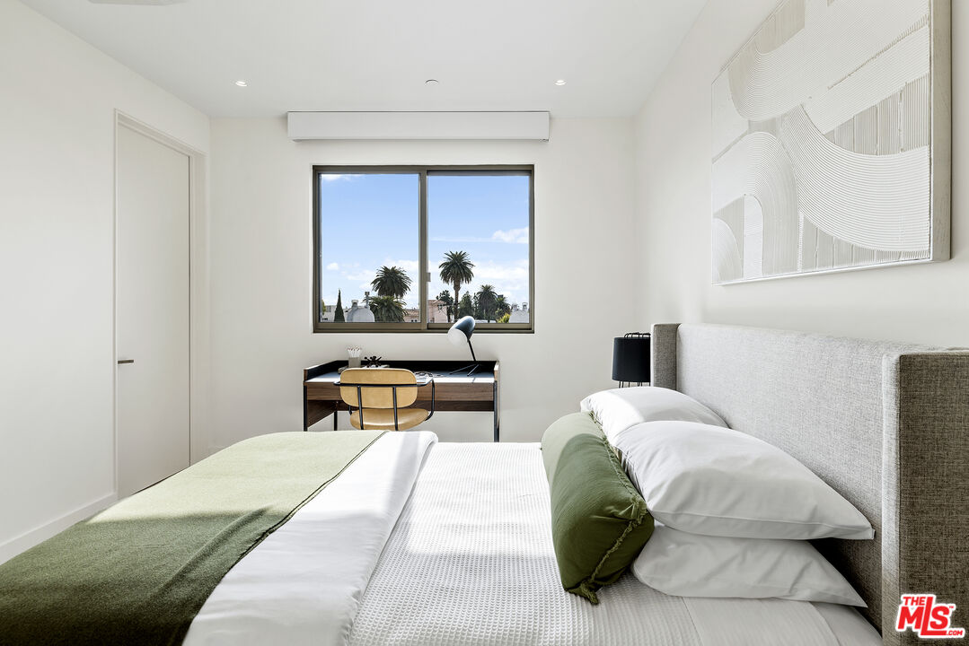 1644 Malcolm Avenue, Unit 420 Los Angeles, CA 90024 - Photo 32 of 64 a bedroom with a bed and a painting on the wall