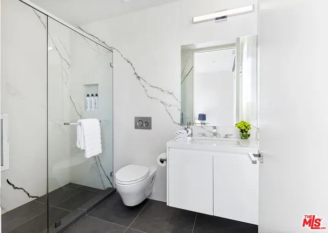 a spacious bathroom with a double vanity sink mirror and bathtub
