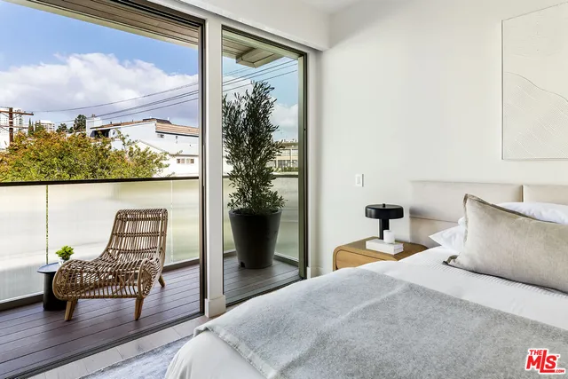 a bedroom with a bed and a desk