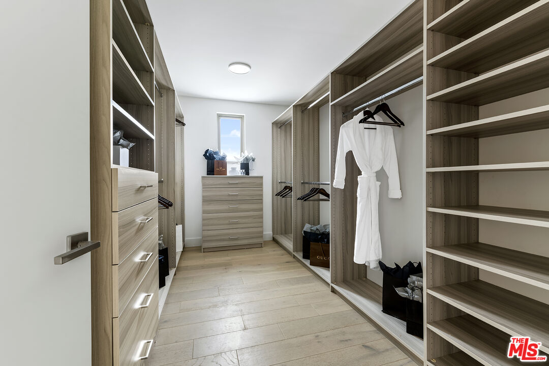 1644 Malcolm Avenue, Unit 420 Los Angeles, CA 90024 - Photo 41 of 64 a view of walk in closet with clothes and shoes