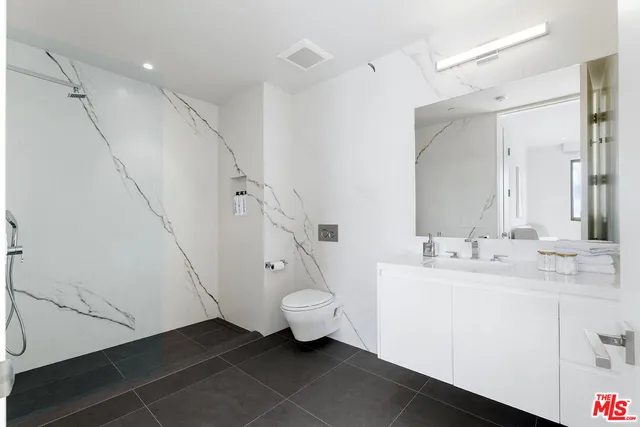 a view of a roof deck with couches and potted plants