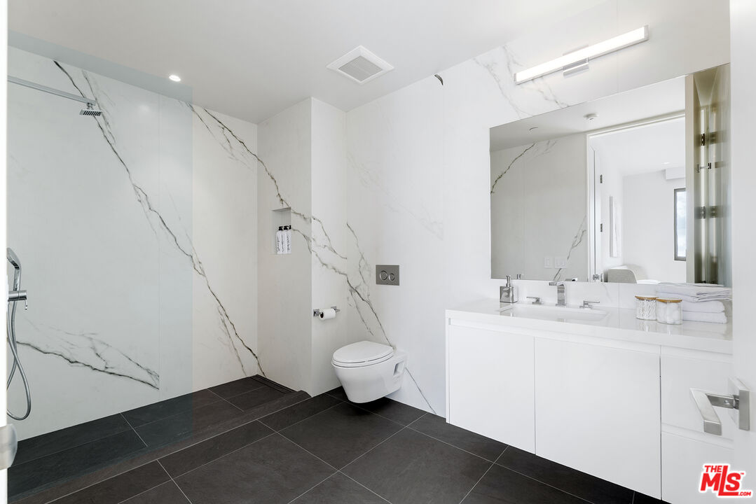 1644 Malcolm Avenue, Unit 420 Los Angeles, CA 90024 - Photo 44 of 64 a bathroom with a double vanity sink and mirror