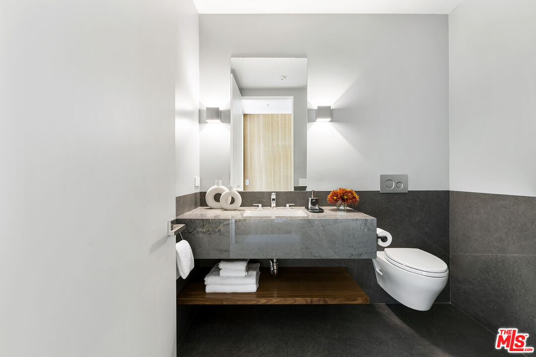 1644 Malcolm Avenue, Unit 420 Los Angeles, CA 90024 - Photo 45 of 64 a bathroom with a sink a toilet and a mirror