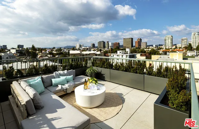 a view of a balcony with dining table and chairs with a swimming pool