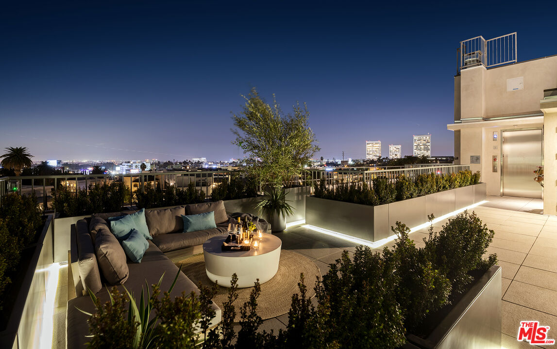 1644 Malcolm Avenue, Unit 420 Los Angeles, CA 90024 - Photo 63 of 64 a view of a balcony with dining table and chairs with a swimming pool