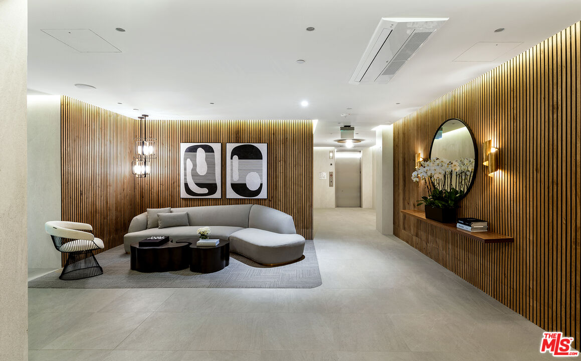 1644 Malcolm Avenue, Unit 420 Los Angeles, CA 90024 - Photo 8 of 64 a living room with furniture and a large mirror