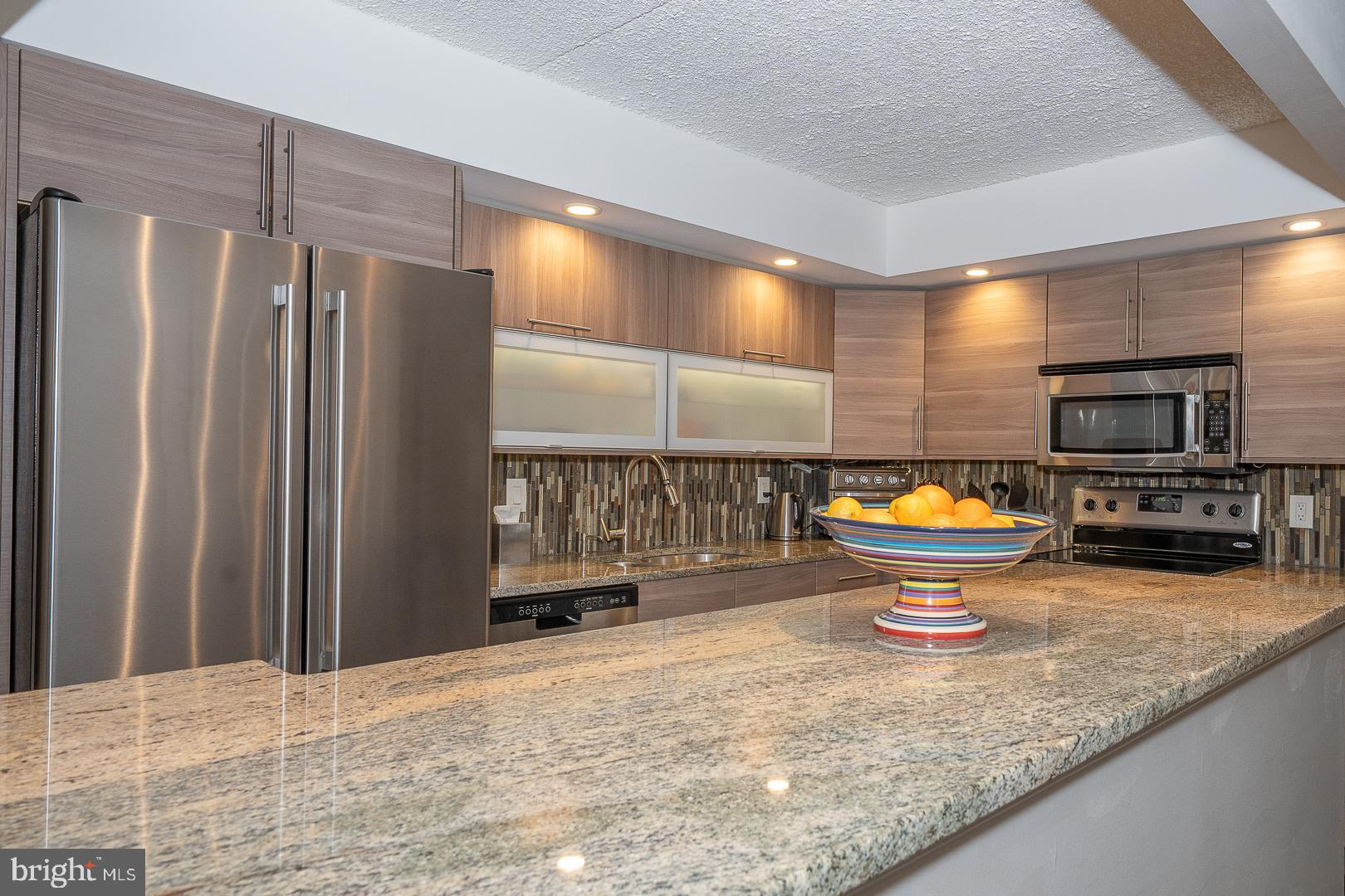 19 Rock Hill Road, Unit 1F Bala Cynwyd, PA 19004 - Photo 16 of 35 a view of a kitchen with a sink and a refrigerator