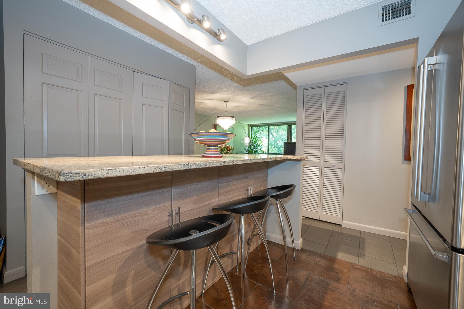 19 Rock Hill Road, Unit 1F Bala Cynwyd, PA 19004 - Photo 17 of 35 a room with a table chairs and chandelier