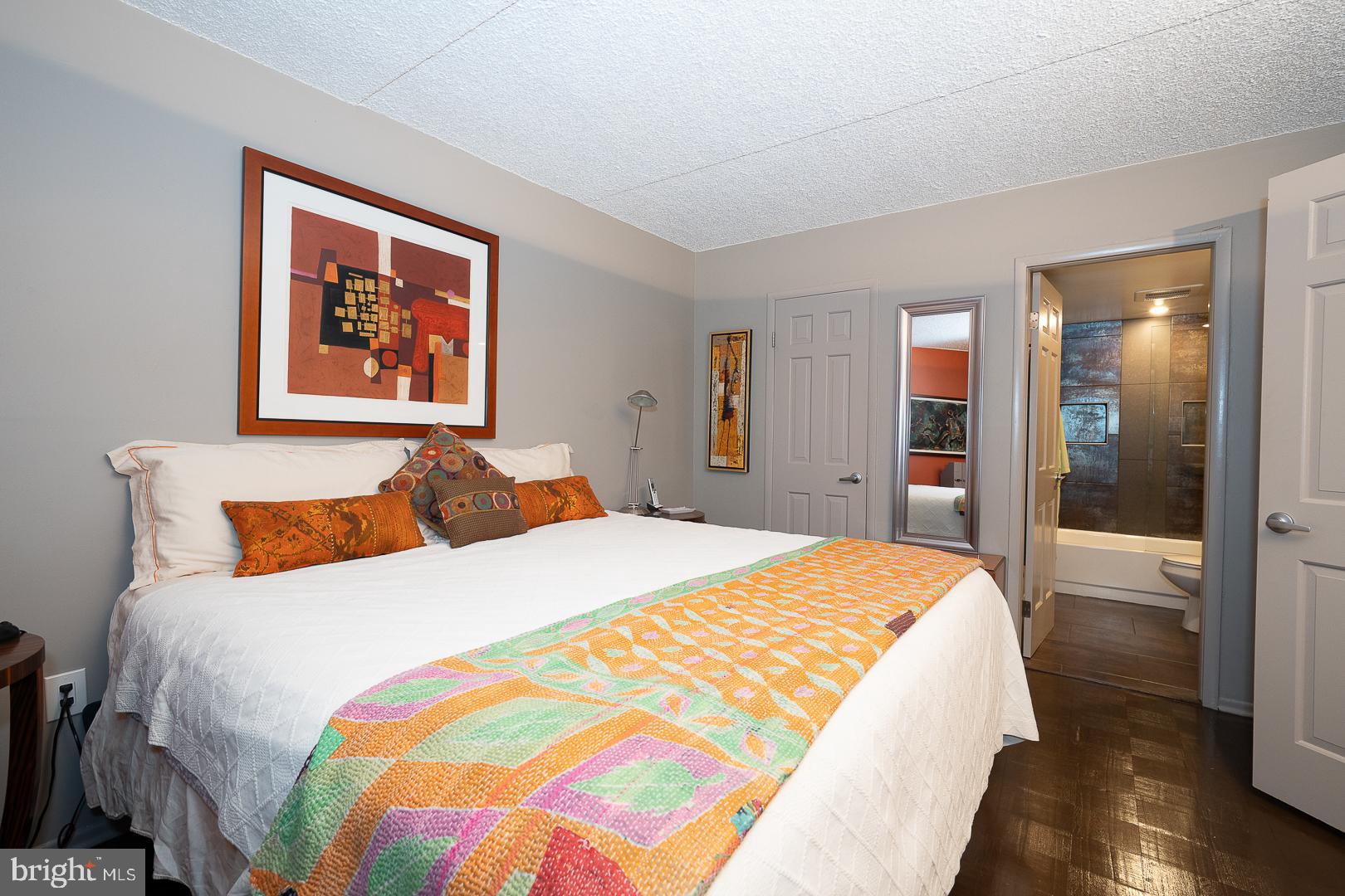 19 Rock Hill Road, Unit 1F Bala Cynwyd, PA 19004 - Photo 20 of 35 a bedroom with a bed and a painting on the wall