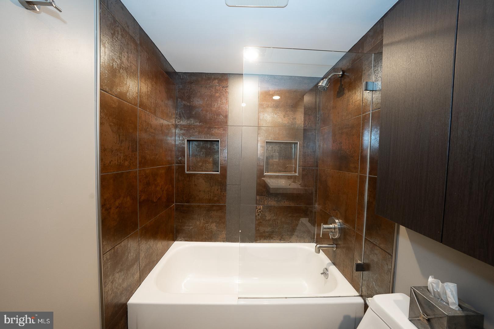 19 Rock Hill Road, Unit 1F Bala Cynwyd, PA 19004 - Photo 23 of 35 a bathroom with a bathtub and a shower