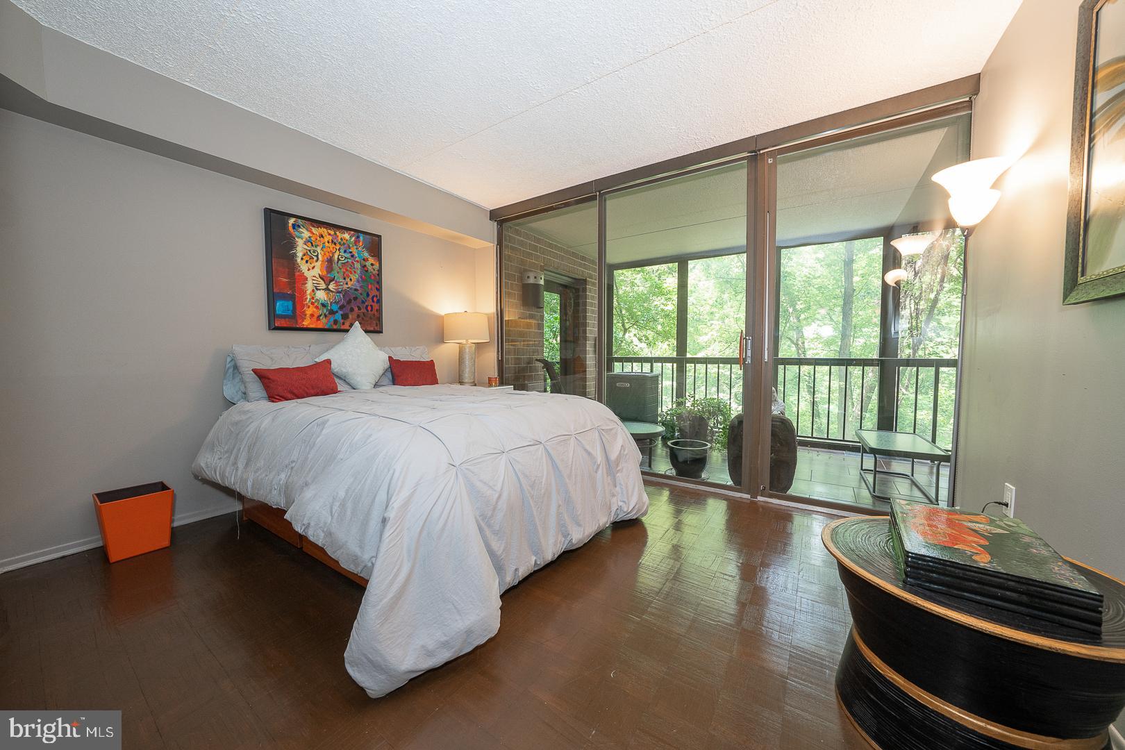19 Rock Hill Road, Unit 1F Bala Cynwyd, PA 19004 - Photo 24 of 35 a bedroom with a bed and a large window