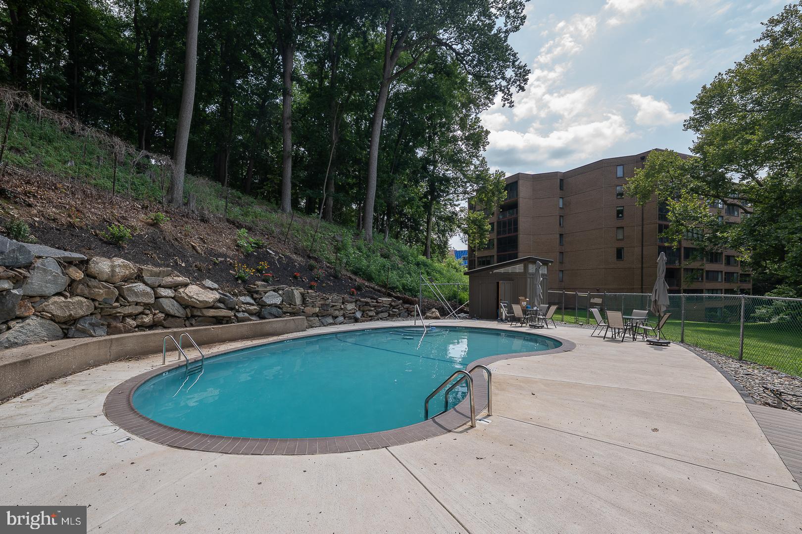 19 Rock Hill Road, Unit 1F Bala Cynwyd, PA 19004 - Photo 32 of 35 a view of a swimming pool with a yard