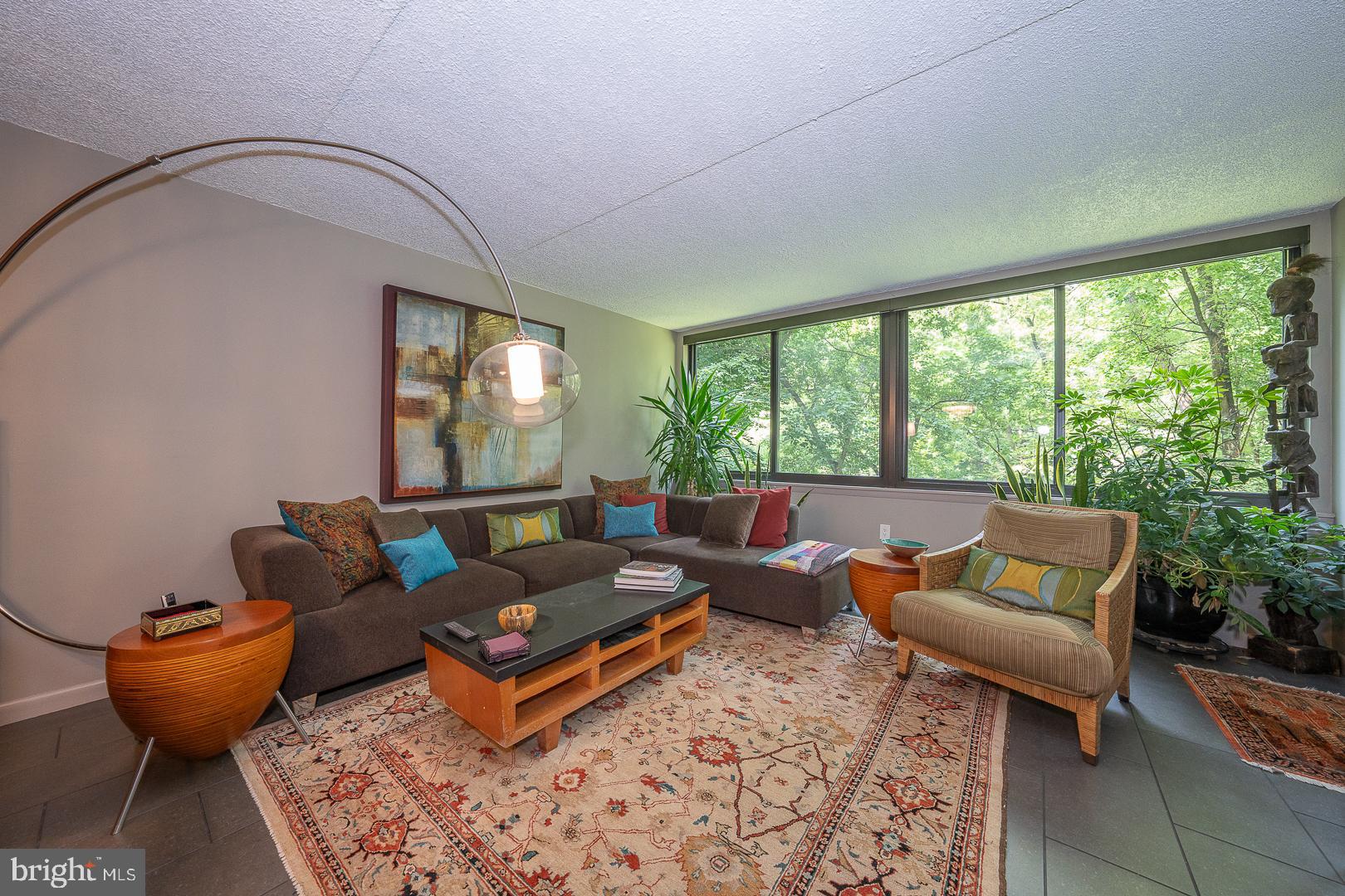 19 Rock Hill Road, Unit 1F Bala Cynwyd, PA 19004 - Photo 7 of 35 a living room with furniture and a large window