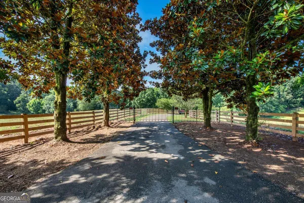 a view of a yard with wooden fence