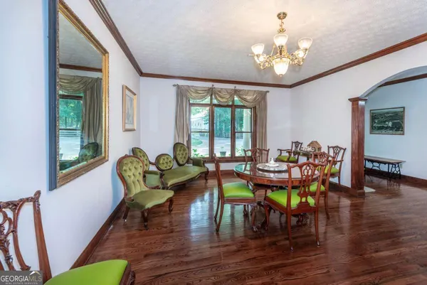 a kitchen with stainless steel appliances granite countertop a refrigerator a sink dishwasher a stove and white countertops with wooden floor